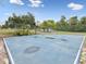 Outdoor basketball court surrounded by a chain-link fence and mature trees at 8393 Delaware Dr, Weeki Wachee, FL 34607