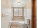 Well-lit bathroom features a tiled shower-over-tub combination and a window at 8393 Delaware Dr, Weeki Wachee, FL 34607