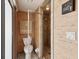 Bathroom with a standing shower behind a glass partition, toilet, and storage unit at 8393 Delaware Dr, Weeki Wachee, FL 34607