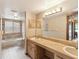 Functional bathroom with double sink vanity, bathtub, shower combo, and ample natural light at 8393 Delaware Dr, Weeki Wachee, FL 34607