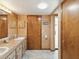 Bathroom featuring double sinks, ample cabinet space, and access to a shower room at 8393 Delaware Dr, Weeki Wachee, FL 34607