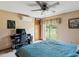Comfortable bedroom with a ceiling fan, and sliding glass door with a view of the backyard at 8393 Delaware Dr, Weeki Wachee, FL 34607