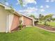 Side exterior of home with landscaped yard and storage shed at 8393 Delaware Dr, Weeki Wachee, FL 34607