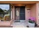 Charming front entrance with a decorative door, potted flowers, and a cozy seating area visible through a window at 8393 Delaware Dr, Weeki Wachee, FL 34607