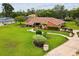 Beautifully landscaped front yard with lush green lawn, shrubbery, and a winding walkway at 8393 Delaware Dr, Weeki Wachee, FL 34607