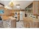 Classic kitchen with appliances, wood cabinets, tile backsplash, and unique lighting at 8393 Delaware Dr, Weeki Wachee, FL 34607