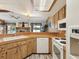 Functional kitchen with vintage-style cabinets, countertops, and appliances with a view of the living area at 8393 Delaware Dr, Weeki Wachee, FL 34607