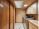 Convenient laundry room with cabinets, countertop space, modern washer and dryer, and ample natural light at 8393 Delaware Dr, Weeki Wachee, FL 34607