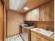 Well-lit laundry room featuring modern washer and dryer, built-in cabinets, and countertops at 8393 Delaware Dr, Weeki Wachee, FL 34607