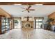 Spacious living room with wood-look floors, a stone fireplace, and sliding glass doors leading to the outdoors at 8393 Delaware Dr, Weeki Wachee, FL 34607
