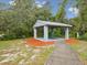 A picnic pavilion with a grill is surrounded by mulch, offering a serene outdoor space at 8393 Delaware Dr, Weeki Wachee, FL 34607