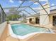 Sparkling private pool is enclosed with a screened lanai and has a nearby patio at 8393 Delaware Dr, Weeki Wachee, FL 34607