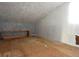 Attic space featuring neutral paint, wood flooring, and natural light, ready for finishing at 8568 Heather Blvd, Weeki Wachee, FL 34613