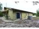 Rear view of home with sliding glass door, patio, and lush landscaping at 8568 Heather Blvd, Weeki Wachee, FL 34613