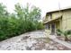 Exterior backyard showing patio, greenery, and a view of the balcony at 8568 Heather Blvd, Weeki Wachee, FL 34613