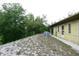 Side view of home with a sandy backyard and some foliage at 8568 Heather Blvd, Weeki Wachee, FL 34613
