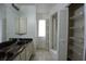 Bathroom with double sinks, cabinet space and a walk-in shower at 8568 Heather Blvd, Weeki Wachee, FL 34613
