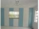 Standard bedroom with 2 windows and featuring bright blue and white painted stripes at 8568 Heather Blvd, Weeki Wachee, FL 34613