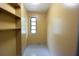 Walk in closet space featuring several shelves and a window at 8568 Heather Blvd, Weeki Wachee, FL 34613