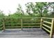 Wooden deck featuring views of surrounding greenery and trees at 8568 Heather Blvd, Weeki Wachee, FL 34613