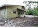 Exterior side view of the home featuring a balcony overlooking the backyard at 8568 Heather Blvd, Weeki Wachee, FL 34613