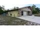 Exterior view of home with attached garage, stone accents, and a driveway at 8568 Heather Blvd, Weeki Wachee, FL 34613