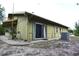 Exterior view of home with a sliding glass door and AC unit. Home could use some TLC at 8568 Heather Blvd, Weeki Wachee, FL 34613