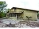 View of the home's exterior and backyard with a balcony overlooking the property at 8568 Heather Blvd, Weeki Wachee, FL 34613
