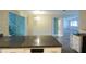 Open concept kitchen with breakfast bar overlooking living area and staircase at 8568 Heather Blvd, Weeki Wachee, FL 34613