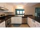 Bright kitchen with stainless steel appliances, granite countertops, and white cabinetry at 8568 Heather Blvd, Weeki Wachee, FL 34613