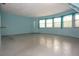 Bright and airy living room with large windows and light blue walls at 8568 Heather Blvd, Weeki Wachee, FL 34613
