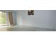 Bright living room with sliding glass doors to the outside and modern art on the wall at 8568 Heather Blvd, Weeki Wachee, FL 34613