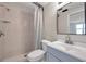 Cozy bathroom featuring a walk-in shower, a toilet, and a modern vanity with a sleek mirror at 9005 Lido Ln, Port Richey, FL 34668