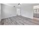Spacious bedroom with ensuite bathroom, wood-look flooring, neutral walls, and natural lighting at 9005 Lido Ln, Port Richey, FL 34668