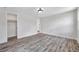 Bright bedroom with wood-look flooring, neutral walls, recessed lighting, and closet at 9005 Lido Ln, Port Richey, FL 34668