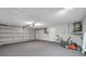 Spacious garage featuring a large roll-up door, with ample space for parking and storage at 9005 Lido Ln, Port Richey, FL 34668