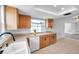 Bright kitchen boasts wood cabinets, white appliances, tile floors and natural light at 9005 Lido Ln, Port Richey, FL 34668
