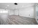 Spacious living room with new floors, neutral walls, recessed lighting, and natural light at 9005 Lido Ln, Port Richey, FL 34668