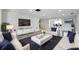 Bright living room with modern furniture, including white sofas and sleek entertainment center at 9005 Lido Ln, Port Richey, FL 34668
