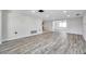 Open-concept living room featuring neutral walls, light floors, and seamless flow to the dining area at 9005 Lido Ln, Port Richey, FL 34668