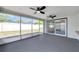 Large screened patio overlooking the backyard features ceiling fans and access to the house at 9005 Lido Ln, Port Richey, FL 34668