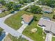 Birds eye view of a home with a lush green lawn surrounded by mature trees in a quiet neighborhood at 9251 Geneva St, Spring Hill, FL 34608