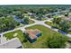 An aerial view captures the home nestled on a sprawling lot with mature trees in a tranquil neighborhood at 9251 Geneva St, Spring Hill, FL 34608
