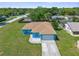 Aerial view of a well-maintained home with a lush green lawn and a spacious driveway at 9251 Geneva St, Spring Hill, FL 34608