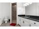 Well-lit bathroom features a single sink vanity, a tiled walk-in shower and neutral wall colors at 9251 Geneva St, Spring Hill, FL 34608