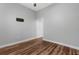 Bedroom with hardwood floors, neutral colors, ceiling fan, and access to a hallway at 9251 Geneva St, Spring Hill, FL 34608