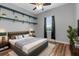 Bedroom featuring hardwood floors, a window and decorative wall shelves above the bed at 9251 Geneva St, Spring Hill, FL 34608