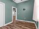 Bedroom with hardwood floors, neutral colors, ceiling fan, and access to another room at 9251 Geneva St, Spring Hill, FL 34608