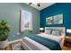 Cozy bedroom with window, hardwood floors, ceiling fan, bed, and modern décor at 9251 Geneva St, Spring Hill, FL 34608