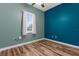 Cozy bedroom with natural light from the window, with hardwood floors and ceiling fan at 9251 Geneva St, Spring Hill, FL 34608